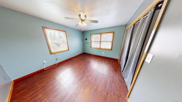 174 Round Hill Rd, Meriden, CT 06450 - unfurnished bedroom with wood finished floors, baseboards, a closet, a textured ceiling, and a ceiling fan