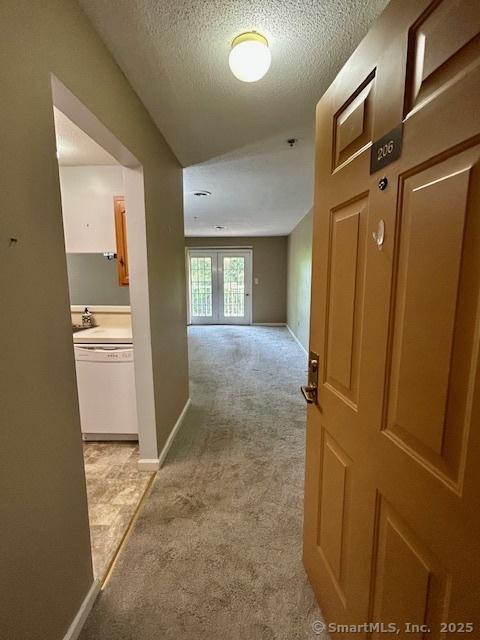 625 Palisado Ave Apt 206, Windsor, CT 06095 - hall featuring light carpet, a textured ceiling, and baseboards