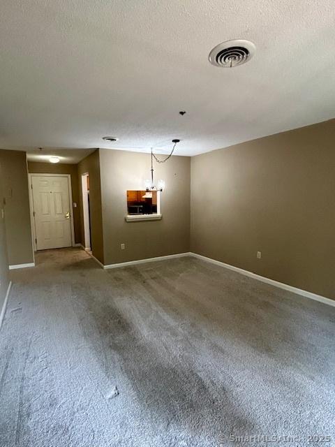 625 Palisado Ave Apt 206, Windsor, CT 06095 - carpeted empty room with a textured ceiling and baseboards