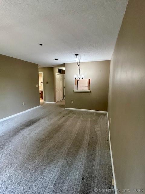 625 Palisado Ave Apt 206, Windsor, CT 06095 - spare room featuring a textured ceiling, baseboards, and carpet