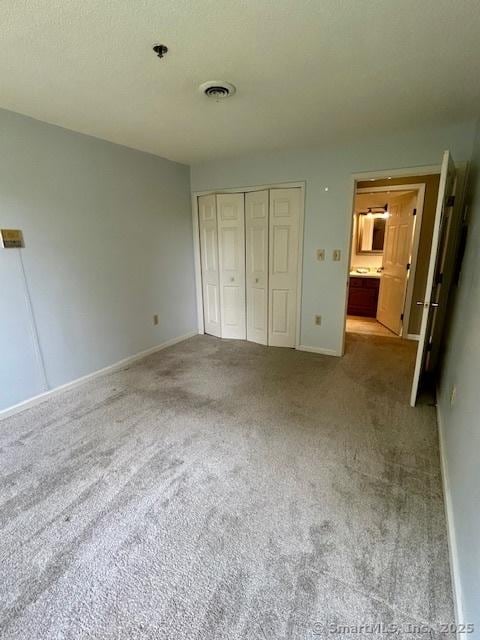 625 Palisado Ave Apt 206, Windsor, CT 06095 - unfurnished bedroom featuring carpet floors, a closet, and baseboards