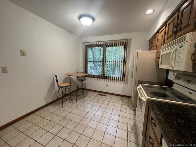 27 Rolling Ridge Rd Unit 27, Monroe, CT 06468 - kitchen featuring white appliances, light tile patterned floors, and dark brown cabinetry