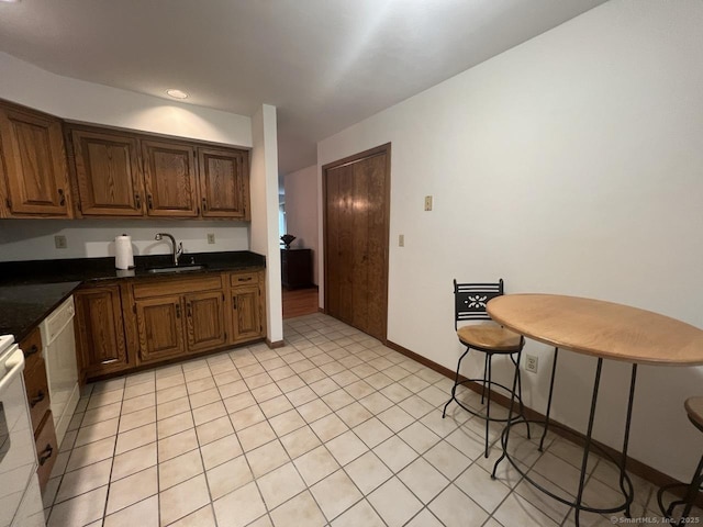 27 Rolling Ridge Rd Unit 27, Monroe, CT 06468 - kitchen with dark countertops, white dishwasher, range, and light tile patterned floors