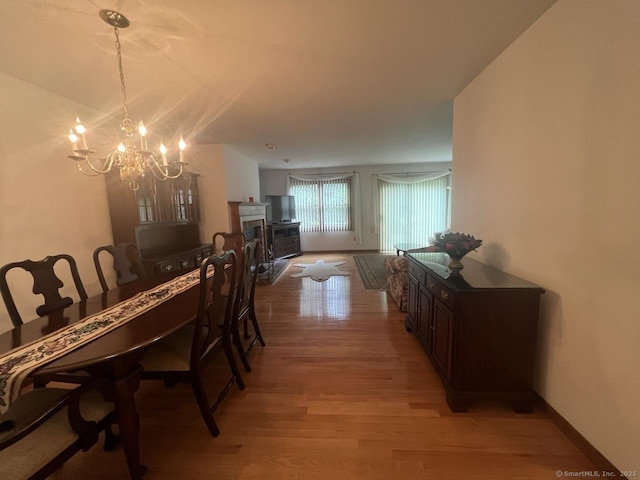 27 Rolling Ridge Rd Unit 27, Monroe, CT 06468 - dining area featuring light wood-type flooring, a chandelier, and a fireplace