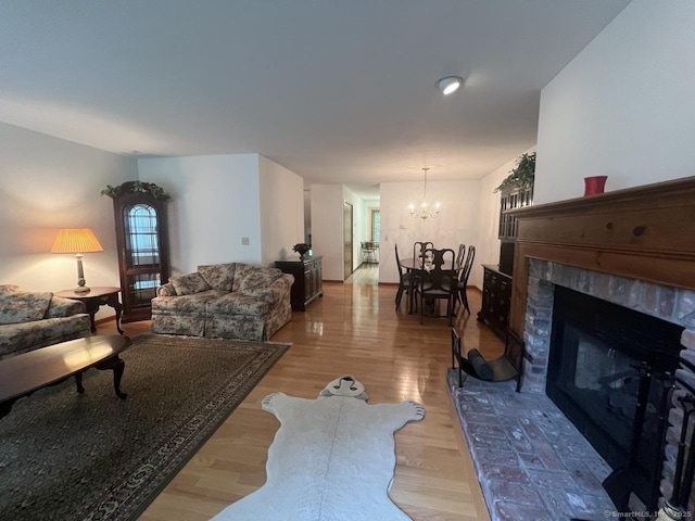 27 Rolling Ridge Rd Unit 27, Monroe, CT 06468 - living area featuring a chandelier, light wood-style flooring, and a brick fireplace