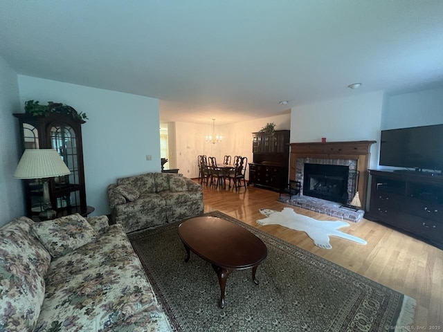 27 Rolling Ridge Rd Unit 27, Monroe, CT 06468 - living room featuring a chandelier, wood finished floors, and a fireplace with raised hearth