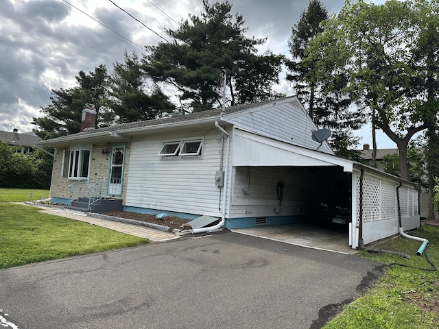 130 Judd Ave, New Britain, CT 06051 - view of front of house with a chimney, a front yard, driveway, entry steps, and a carport