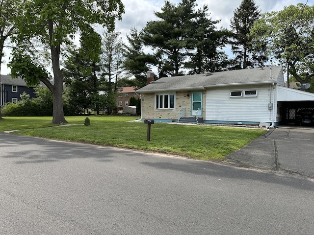 130 Judd Ave, New Britain, CT 06051 - view of front of house with a front lawn, a carport, a chimney, and asphalt driveway