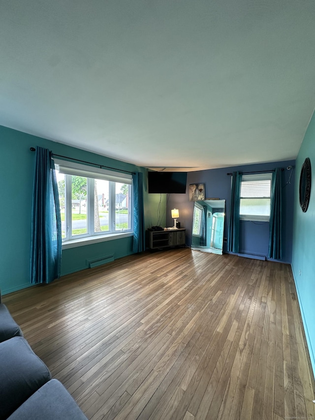 130 Judd Ave, New Britain, CT 06051 - unfurnished living room with hardwood / wood-style floors, baseboard heating, and baseboards