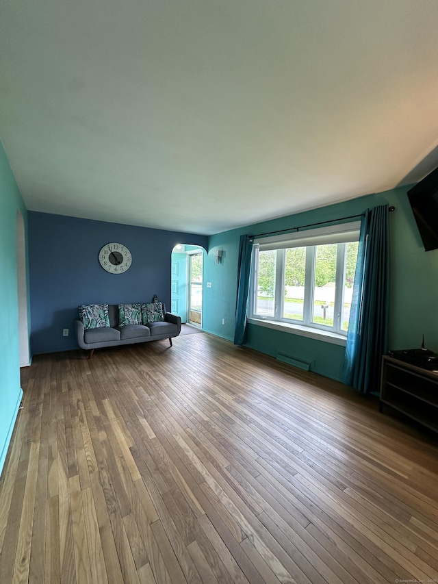 130 Judd Ave, New Britain, CT 06051 - unfurnished living room featuring arched walkways and hardwood / wood-style floors