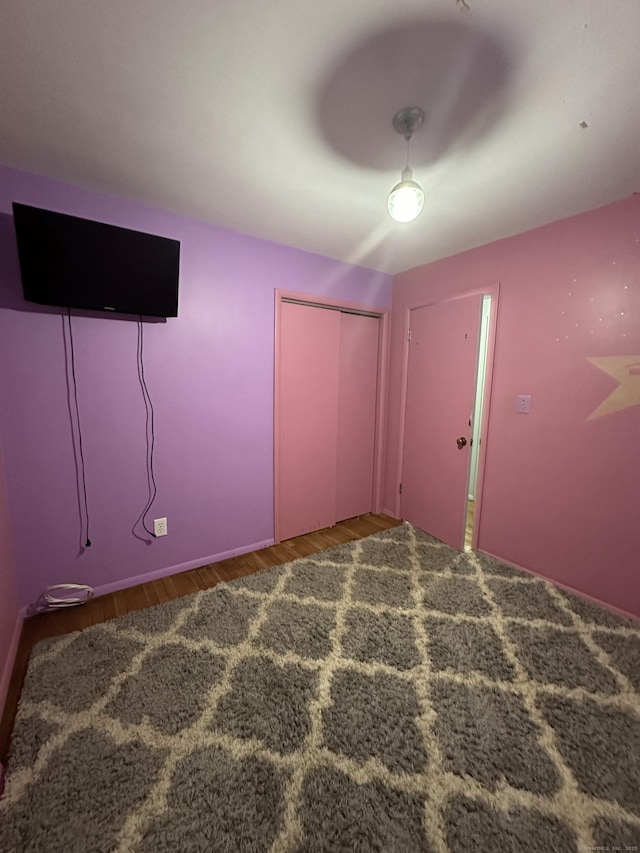 130 Judd Ave, New Britain, CT 06051 - unfurnished bedroom featuring wood finished floors, a closet, a ceiling fan, and baseboards