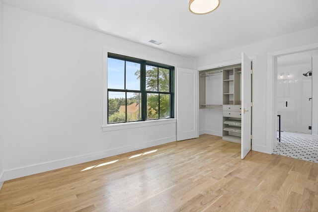 52 Garibaldi Ln, New Canaan, CT 06840 - unfurnished bedroom with light wood-style floors, baseboards, and a closet