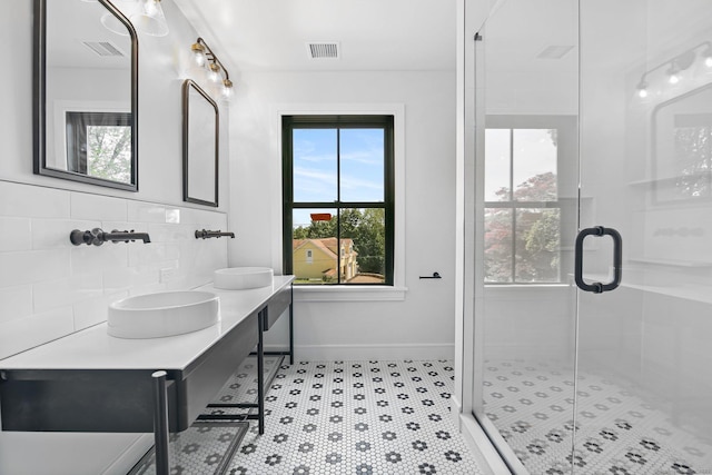 52 Garibaldi Ln, New Canaan, CT 06840 - bathroom featuring a shower stall, double vanity, baseboards, and decorative backsplash