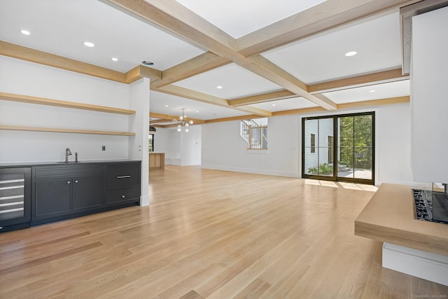 52 Garibaldi Ln, New Canaan, CT 06840 - living area featuring beverage cooler, wet bar, a chandelier, light wood finished floors, and beam ceiling