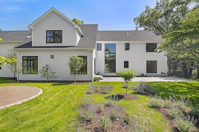 52 Garibaldi Ln, New Canaan, CT 06840 - back of property with a lawn and a shingled roof