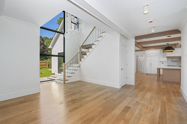 52 Garibaldi Ln, New Canaan, CT 06840 - unfurnished living room featuring stairs, light wood finished floors, baseboards, and beamed ceiling