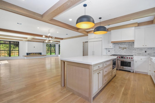 52 Garibaldi Ln, New Canaan, CT 06840 - kitchen with designer range, tasteful backsplash, beamed ceiling, light wood-style floors, and a center island