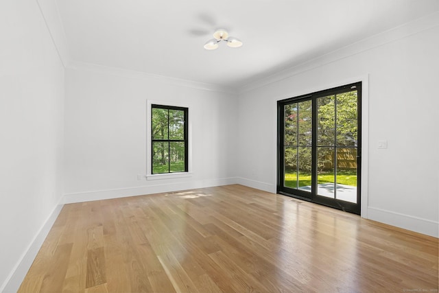 52 Garibaldi Ln, New Canaan, CT 06840 - empty room with ornamental molding, light wood finished floors, and baseboards