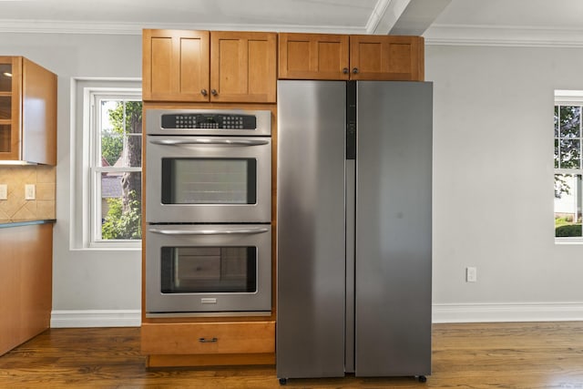 28 Chestnut St, Windsor Locks, CT 06096 - kitchen with appliances with stainless steel finishes, crown molding, dark wood-style flooring, baseboards, and healthy amount of natural light