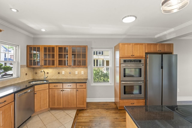 28 Chestnut St, Windsor Locks, CT 06096 - kitchen featuring stainless steel appliances, a sink, dark stone countertops, glass insert cabinets, and tasteful backsplash