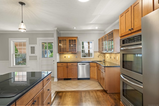 28 Chestnut St, Windsor Locks, CT 06096 - kitchen with appliances with stainless steel finishes, a sink, backsplash, healthy amount of natural light, and crown molding