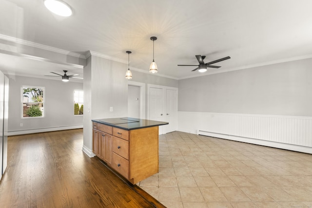 28 Chestnut St, Windsor Locks, CT 06096 - kitchen with a ceiling fan, a baseboard heating unit, open floor plan, dark countertops, and ornamental molding