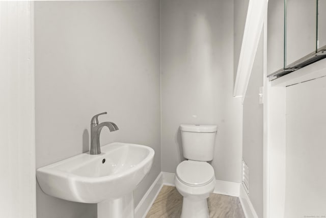 28 Chestnut St, Windsor Locks, CT 06096 - half bath with toilet, a sink, and baseboards