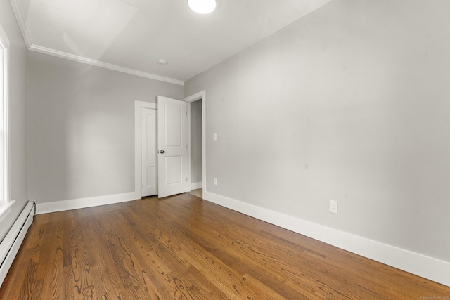 28 Chestnut St, Windsor Locks, CT 06096 - empty room featuring baseboard heating, crown molding, baseboards, and wood finished floors
