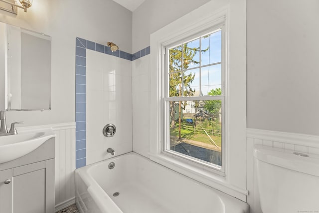 28 Chestnut St, Windsor Locks, CT 06096 - bathroom featuring vanity, a wainscoted wall, tub / shower combination, and toilet