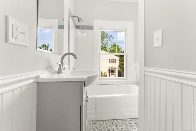28 Chestnut St, Windsor Locks, CT 06096 - bathroom featuring vanity, a decorative wall, a wainscoted wall, a tub to relax in, and a shower