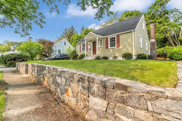 226 Quinn St, Naugatuck, CT 06770 - view of front facade featuring a shingled roof, a front lawn, cooling unit, and a chimney