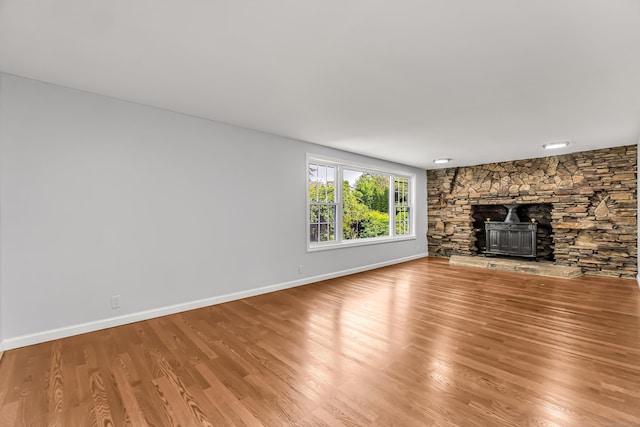 226 Quinn St, Naugatuck, CT 06770 - unfurnished living room with wood finished floors, baseboards, and a stone fireplace
