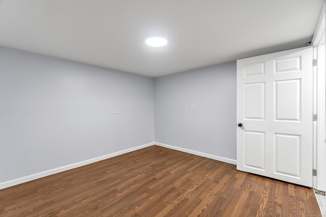 226 Quinn St, Naugatuck, CT 06770 - empty room featuring baseboards and dark wood-style floors