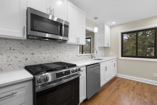 513 Opa Ln Unit B, Stratford, CT 06614 - kitchen featuring appliances with stainless steel finishes, a sink, plenty of natural light, white cabinetry, and recessed lighting