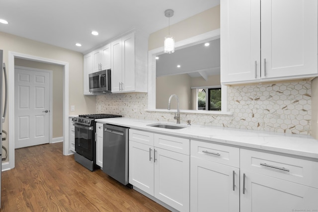 513 Opa Ln Unit B, Stratford, CT 06614 - kitchen featuring appliances with stainless steel finishes, a sink, white cabinets, dark wood-style floors, and recessed lighting