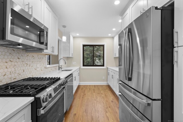 513 Opa Ln Unit B, Stratford, CT 06614 - kitchen featuring stainless steel appliances, a sink, baseboards, white cabinetry, and recessed lighting