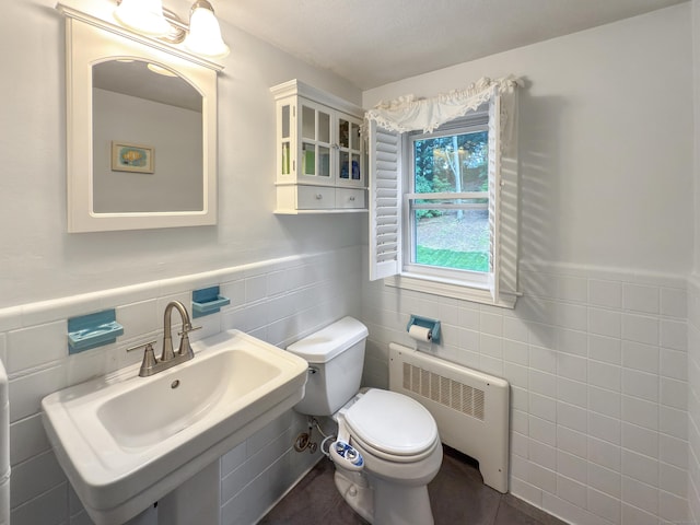 43 Superior Ave, Newington, CT 06111 - bathroom with radiator heating unit, tile walls, toilet, a wainscoted wall, and a sink