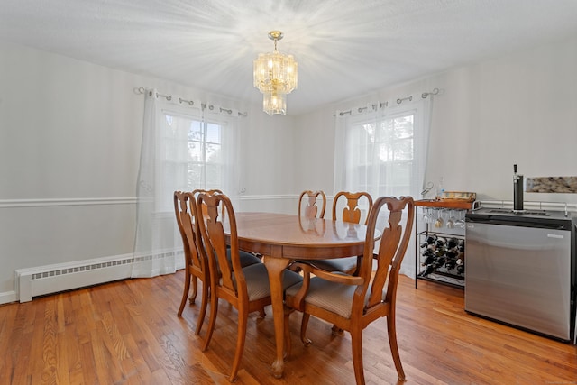 43 Superior Ave, Newington, CT 06111 - dining area featuring healthy amount of natural light, a chandelier, light wood-style flooring, and bar