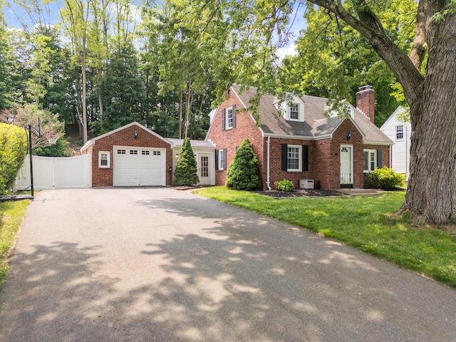 43 Superior Ave, Newington, CT 06111 - new england style home with brick siding, a garage, asphalt driveway, a chimney, and roof with shingles