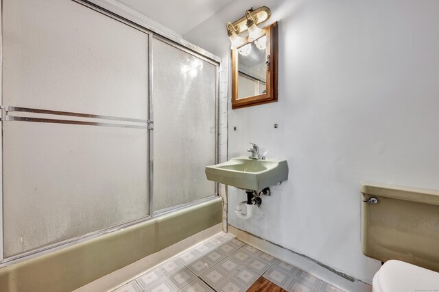 87 Clinic Dr Unit 3A, New Britain, CT 06051 - bathroom with tile patterned floors, enclosed tub / shower combo, toilet, and a sink