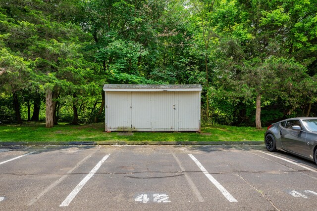 87 Clinic Dr Unit 3A, New Britain, CT 06051 - uncovered parking lot with a shed