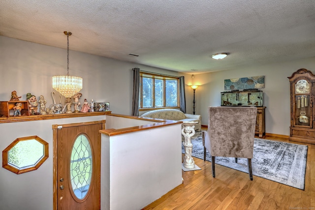 50 Sea Hill Rd, North Branford, CT 06471 - entrance foyer with wood finished floors, a textured ceiling, and a chandelier