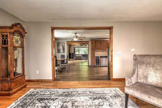 50 Sea Hill Rd, North Branford, CT 06471 - sitting room featuring light wood-style flooring, a ceiling fan, a textured ceiling, and baseboards