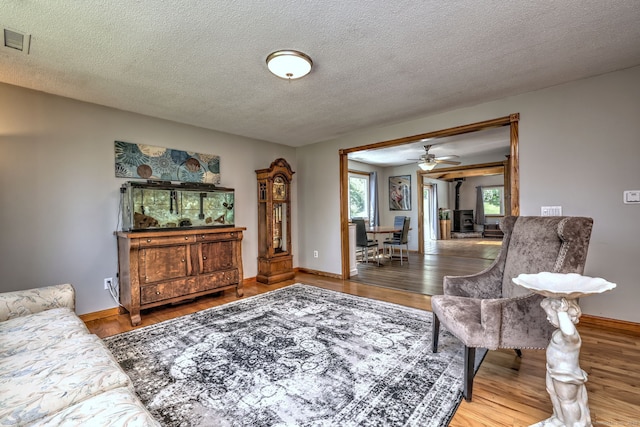 50 Sea Hill Rd, North Branford, CT 06471 - living room featuring baseboards, a textured ceiling, wood finished floors, and ceiling fan