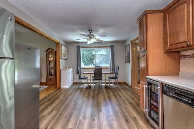 50 Sea Hill Rd, North Branford, CT 06471 - kitchen featuring appliances with stainless steel finishes, a textured ceiling, light countertops, wine cooler, and brown cabinets