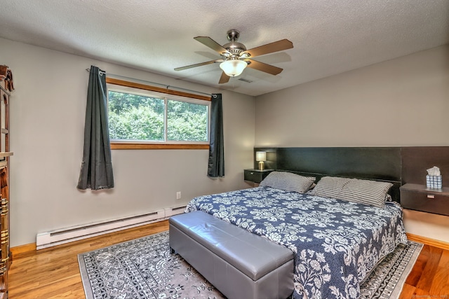 50 Sea Hill Rd, North Branford, CT 06471 - bedroom with a baseboard radiator, wood finished floors, ceiling fan, and a textured ceiling