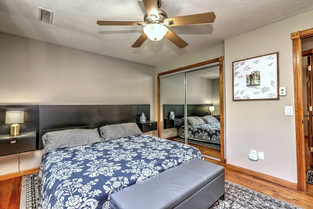 50 Sea Hill Rd, North Branford, CT 06471 - bedroom featuring wood finished floors, a closet, a textured ceiling, and a ceiling fan