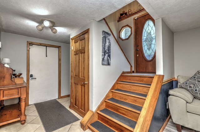 50 Sea Hill Rd, North Branford, CT 06471 - foyer with a textured ceiling, stairway, and light tile patterned flooring
