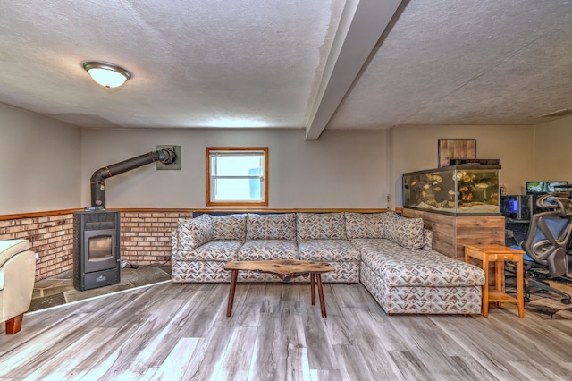 50 Sea Hill Rd, North Branford, CT 06471 - living room featuring a wood stove, wood finished floors, a wainscoted wall, and a textured ceiling