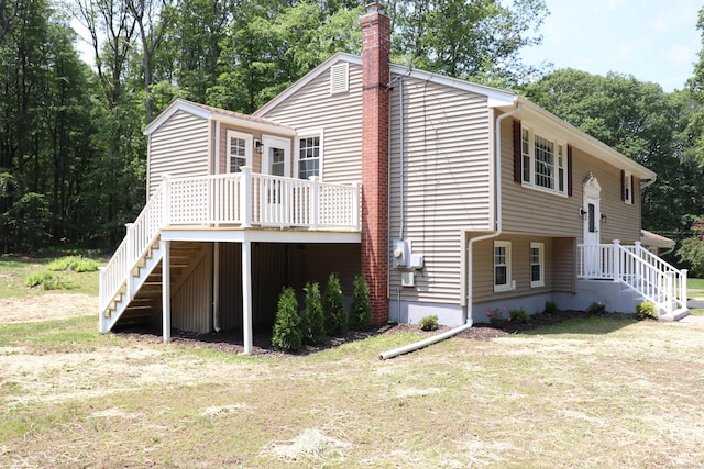 197 New Rd, Tolland, CT 06084 - back of property featuring stairs, a chimney, a yard, and a deck